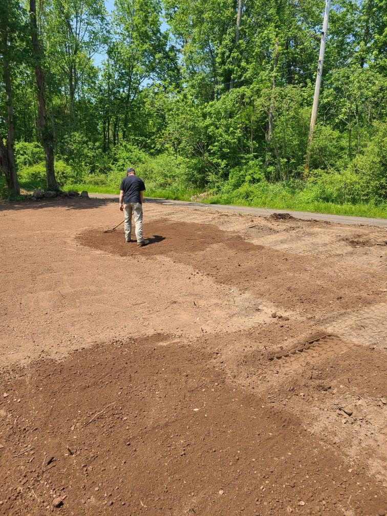 A man is standing in a field of dirt.
