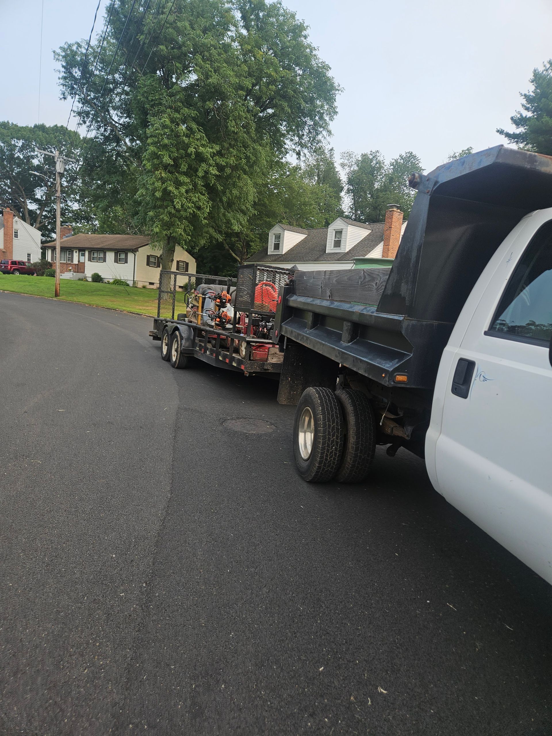 A dump truck with a trailer attached to it