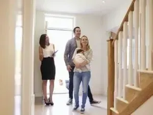 A family is looking at a house with a real estate agent.