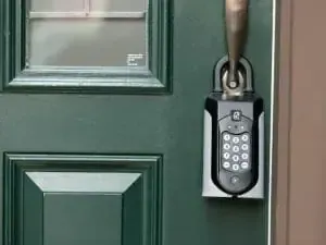 A green door with a keypad on it.