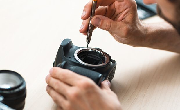 A man repairing a camera