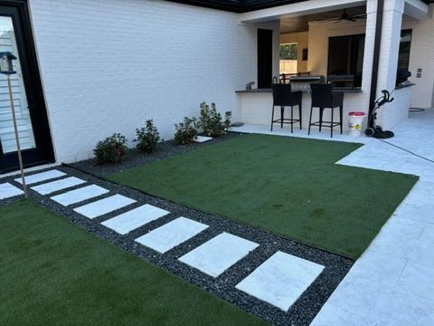A patio with a walkway leading to a kitchen