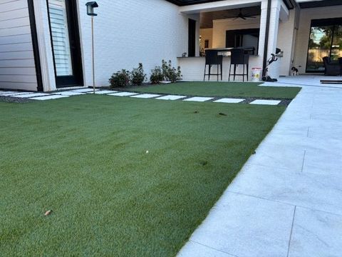 A house with a lawn and a walkway leading to it