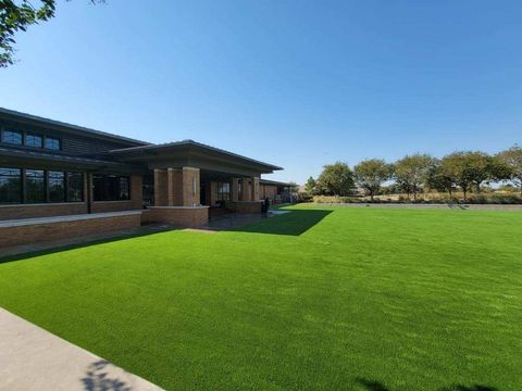 A large lawn in front of a building on a sunny day.