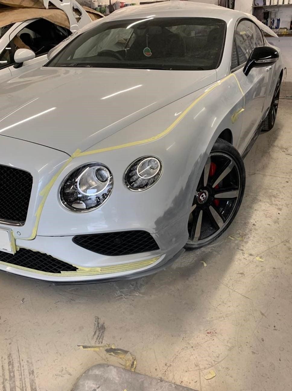 white bentley gt continental undergoing paint work