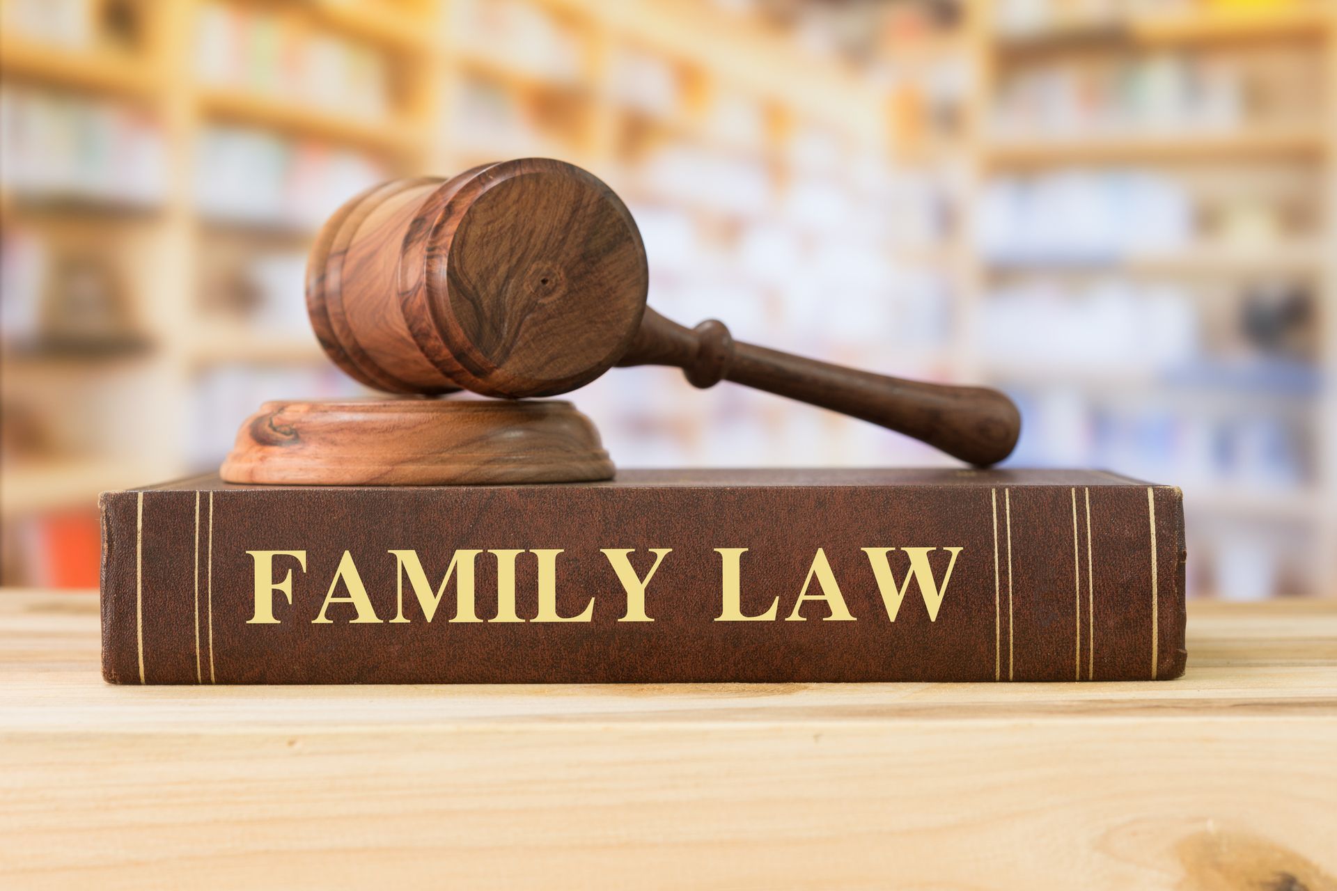 Family law books and a judge’s gavel on a library desk.
