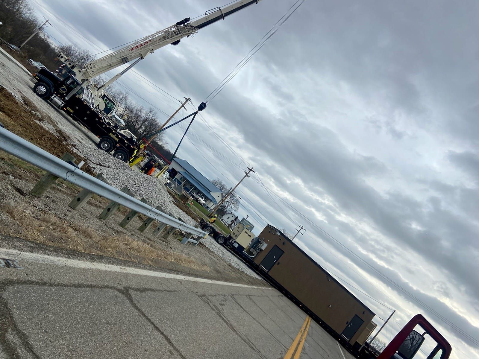 A large crane is sitting on the side of the road