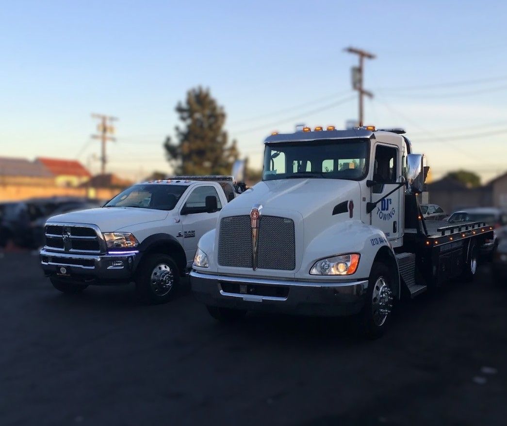 2 White service tow truck with lights on