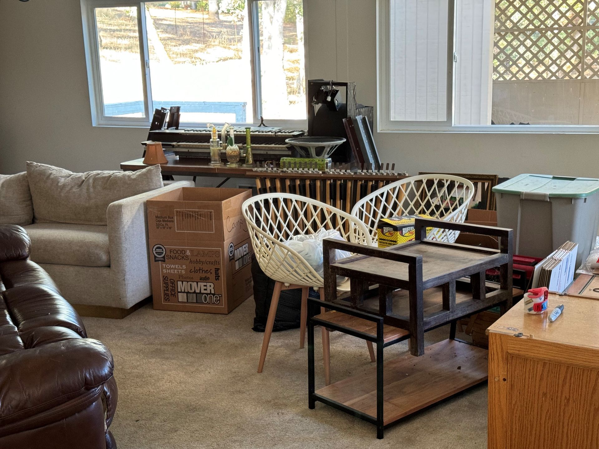 A living room filled with furniture and boxes.