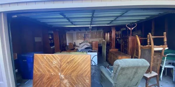 A garage filled with furniture and a table and chairs.