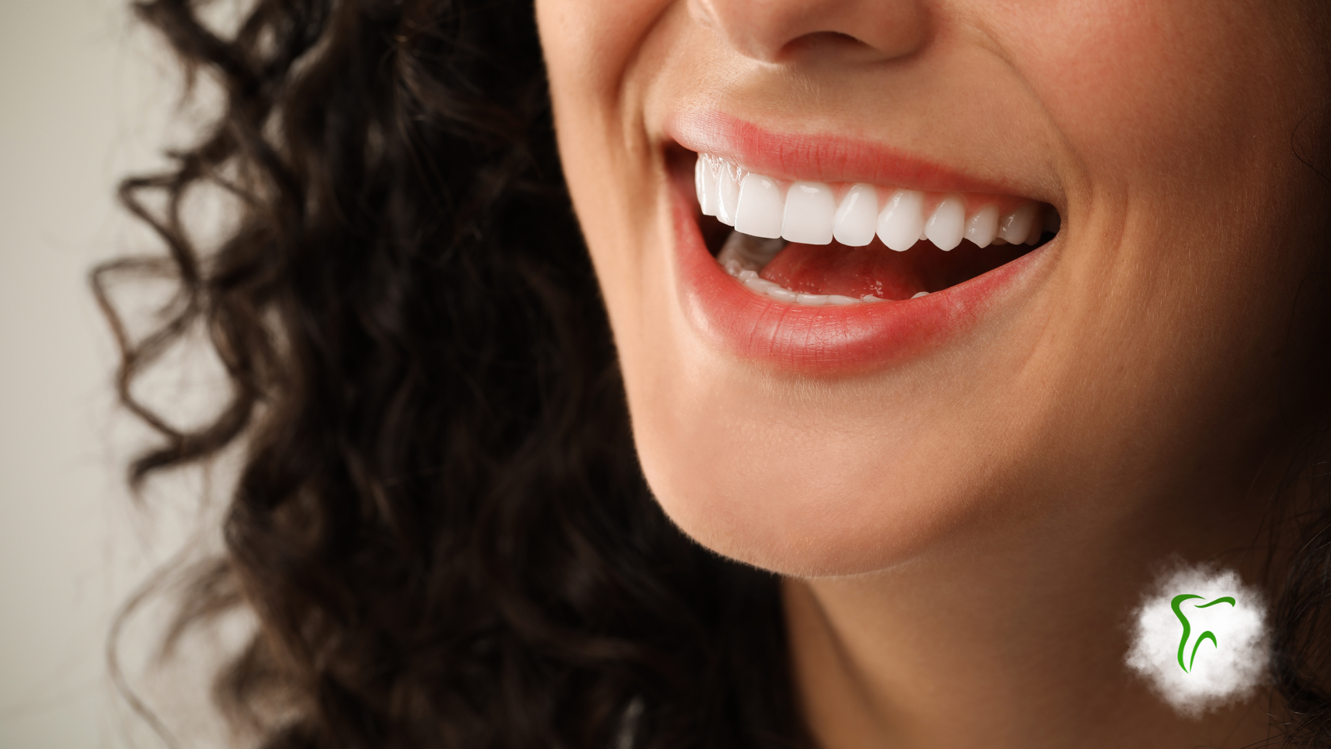 Woman smiling, showing white teeth.
