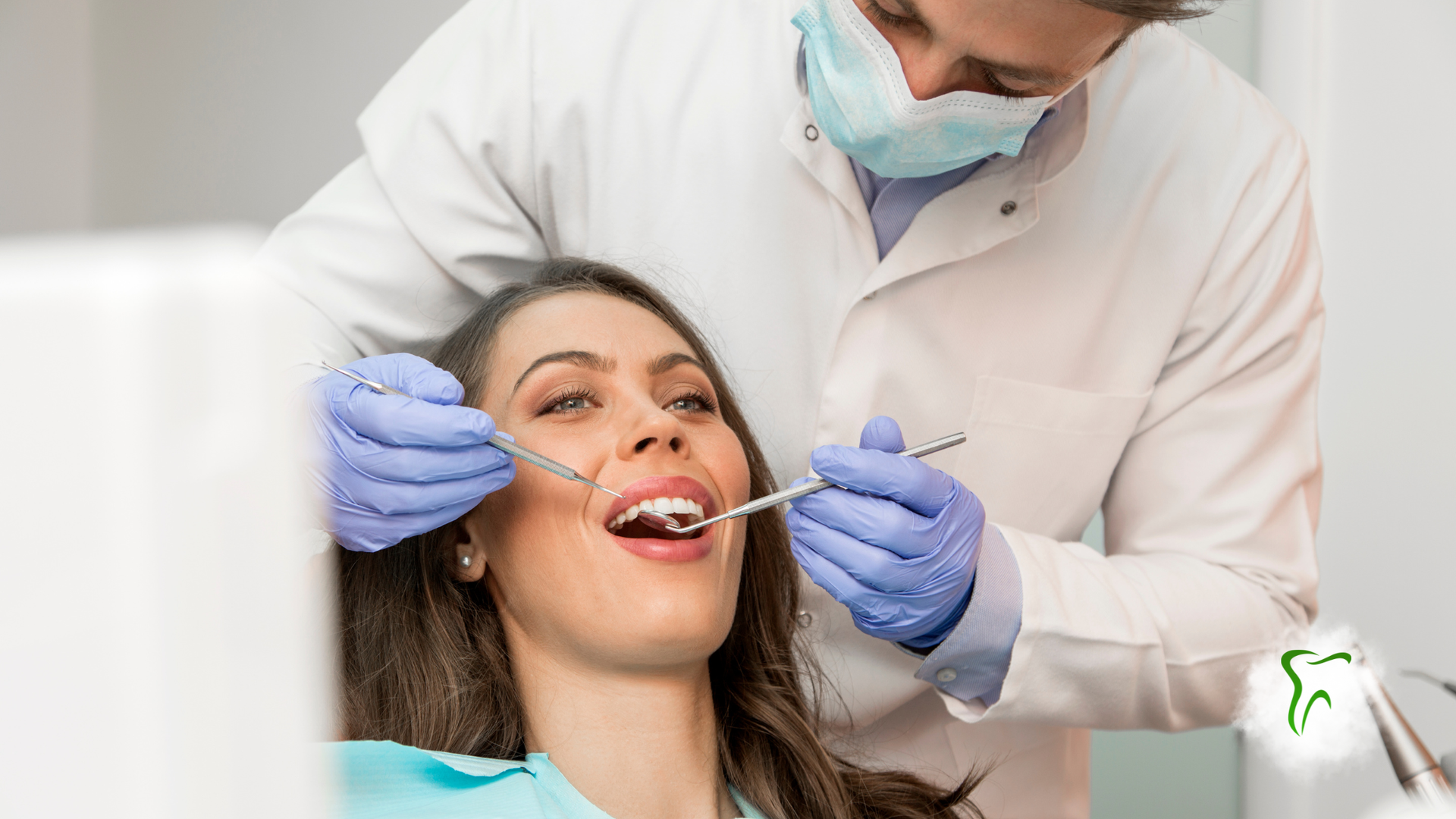 Dentist examining a patient's teeth. The woman is seated, mouth open, as the dentist uses dental tools.
