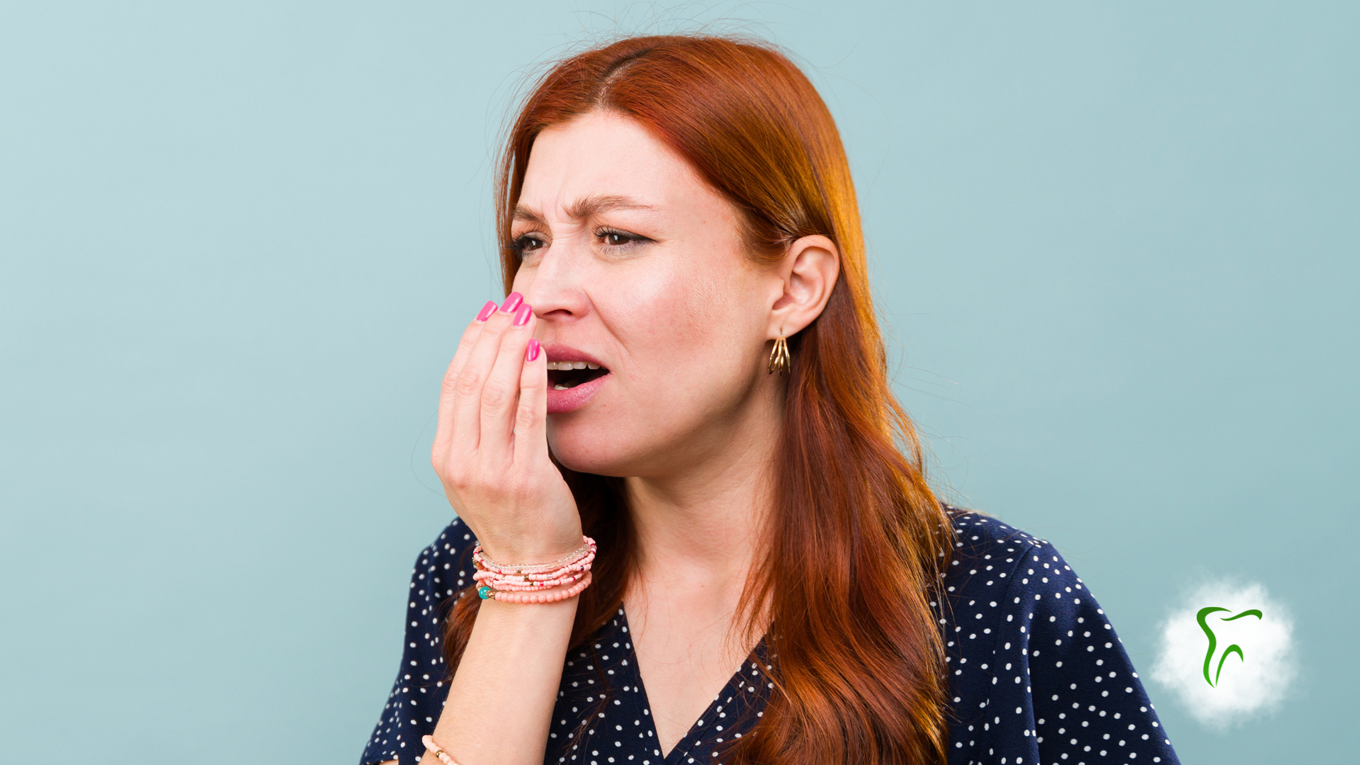 Woman checking breath, covering mouth with hand, concerned expression.