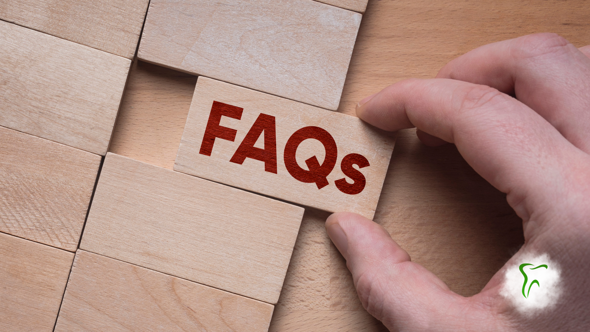 Hand placing a wooden block labeled