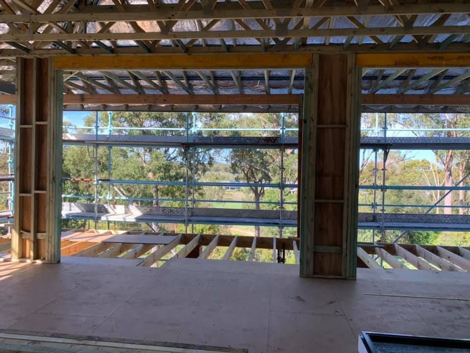 Partially Constructed Building With Wooden Beams and Scaffolding — McNamara's Frames & Trusses In Kempsey, NSW