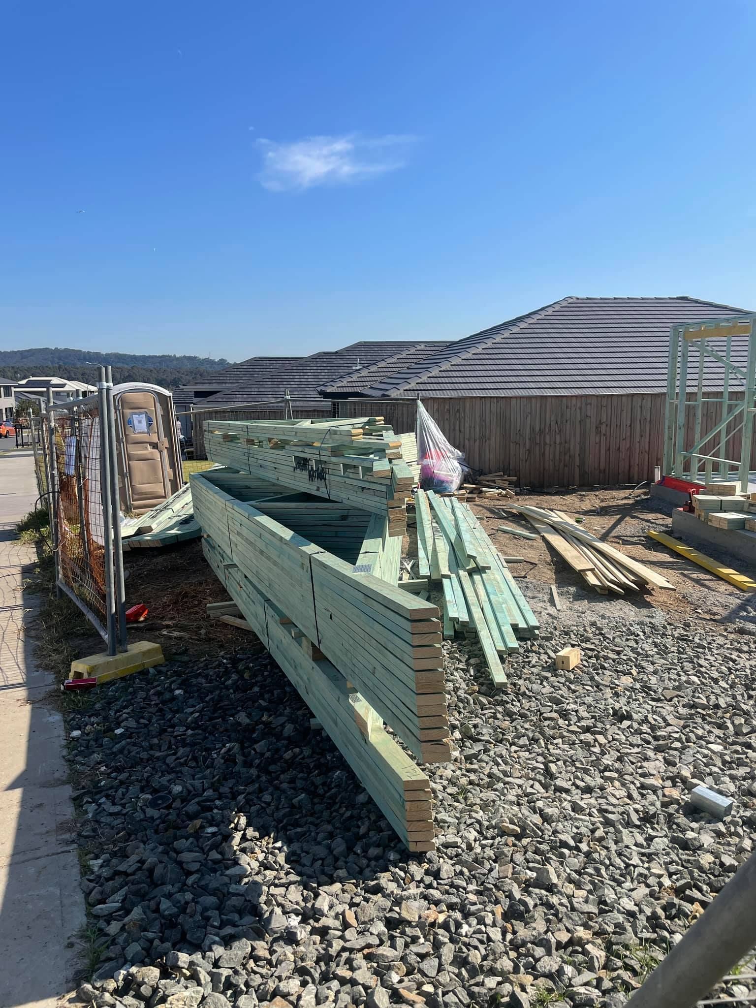 Construction Site With Stacks of Green-treated Lumber — McNamara's Frames & Trusses In Coffs Harbour, NSW