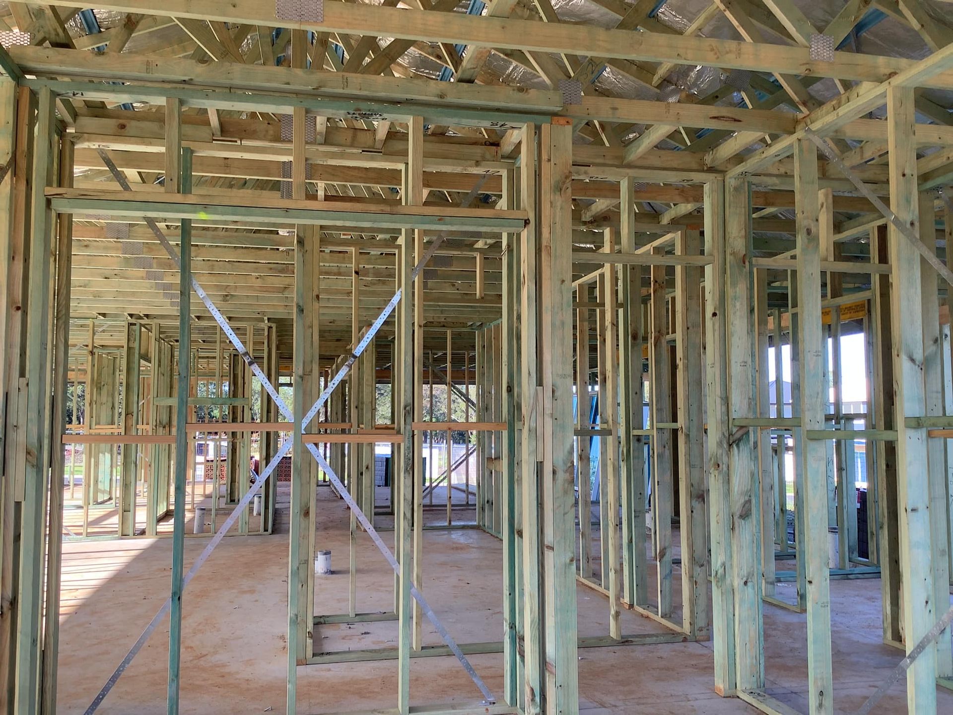 A Building Under Construction, Showing Wooden Frame Walls and Ceiling — McNamara's Frames & Trusses In Newcastle, NSW