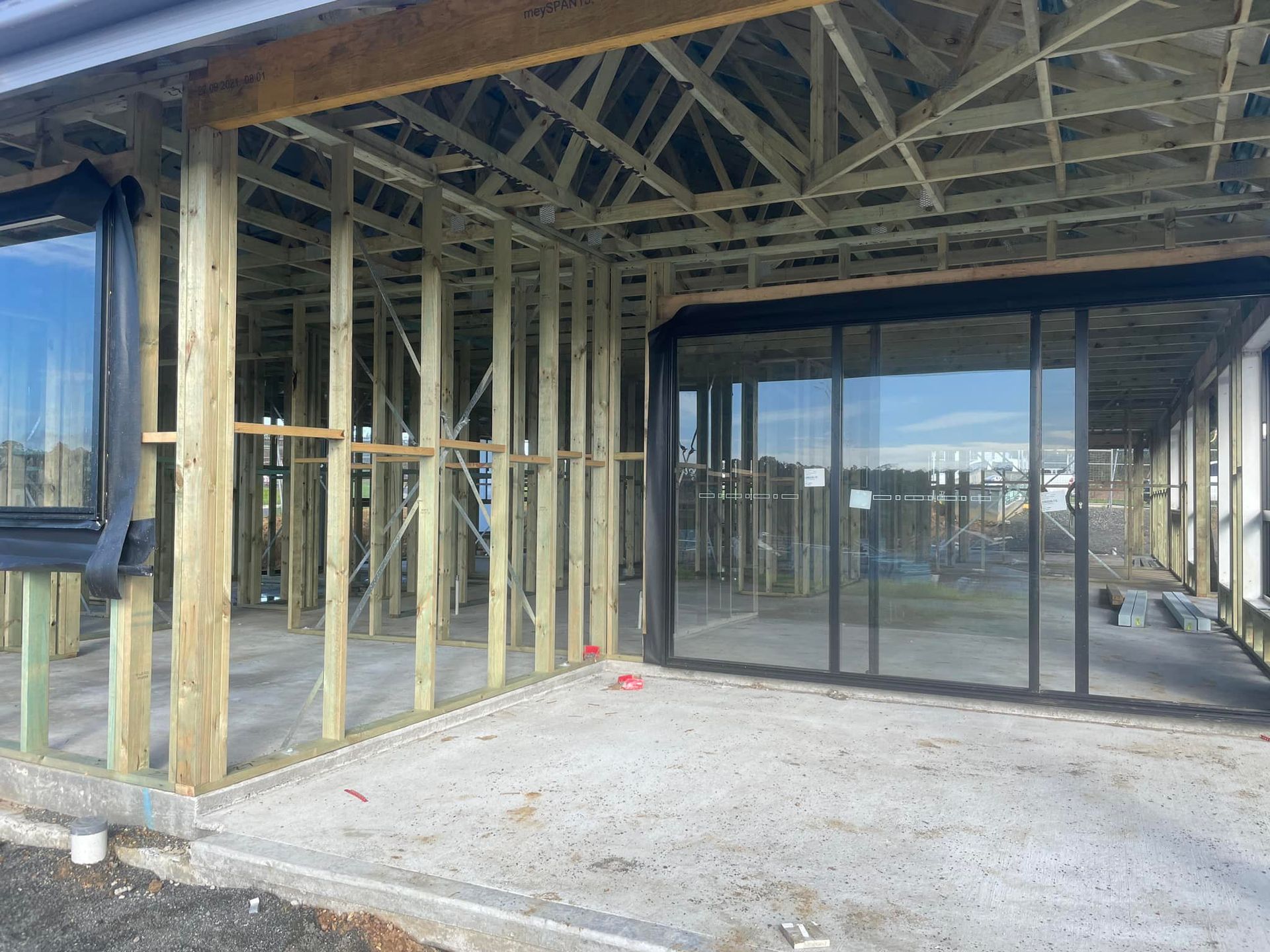 Framing of a House With Glass Sliding Doors and Windows — McNamara's Frames & Trusses In Port Stephens, NSW