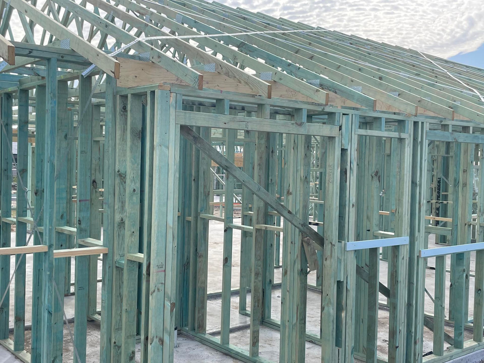 Green Treated Lumber House Frame Under Construction — McNamara's Frames & Trusses In Hunter Valley, NSW