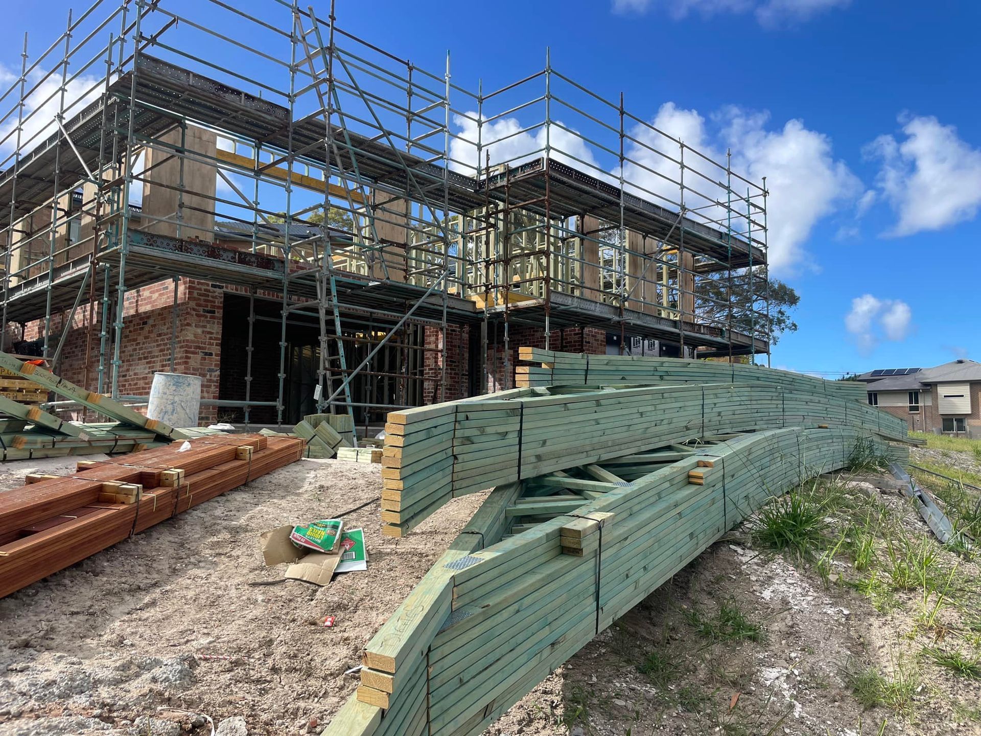 A Two-story Building Under Construction With Scaffolding — McNamara's Frames & Trusses In Gosford, NSW
