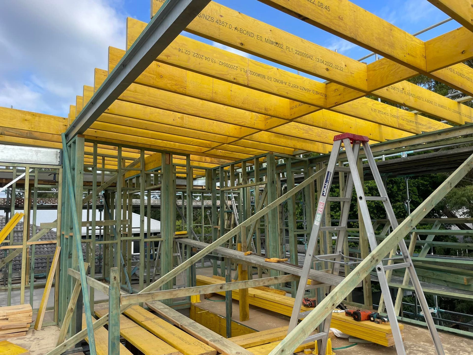 Construction Site With Wooden Framing and Yellow Scaffolding Boards — McNamara's Frames & Trusses In Gosford, NSW