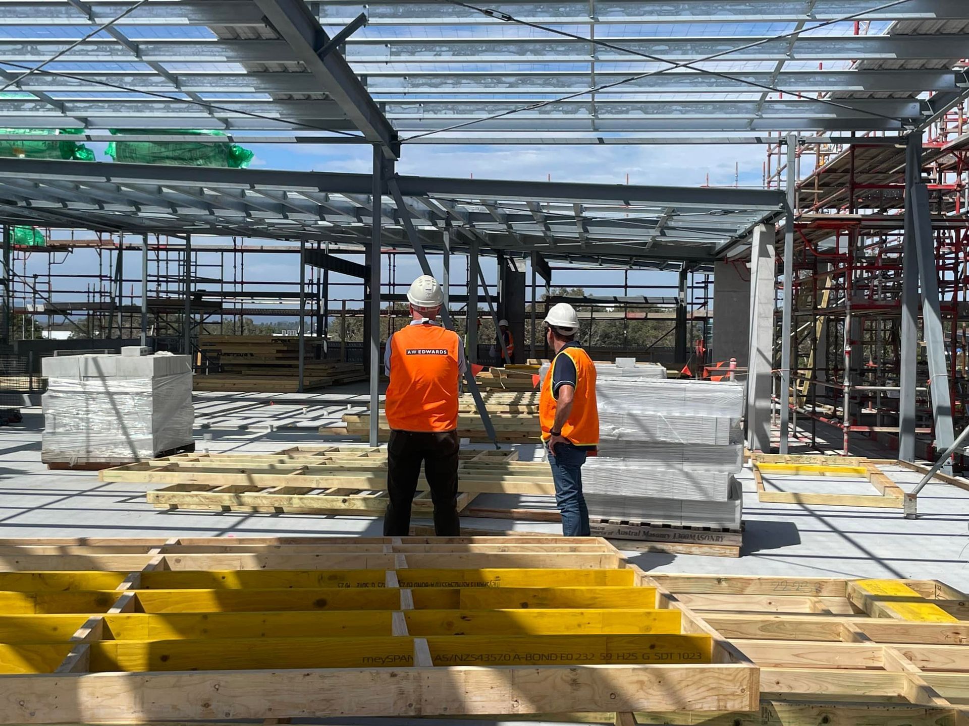 Two Construction Workers on a Building Site — McNamara's Frames & Trusses In Forster, NSW