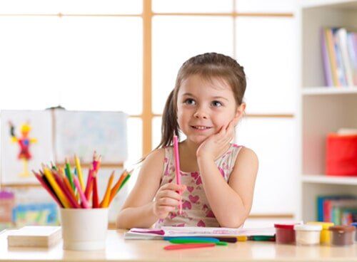 Girl with Coloring Pencils — Woodlands Child Care Centre in Albury, NSW