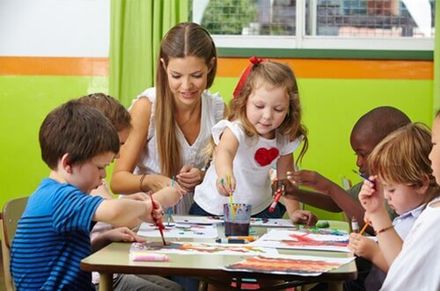 Child care professional during Painting Class with children