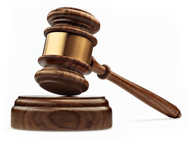 Wooden gavel resting on a block, angled right.