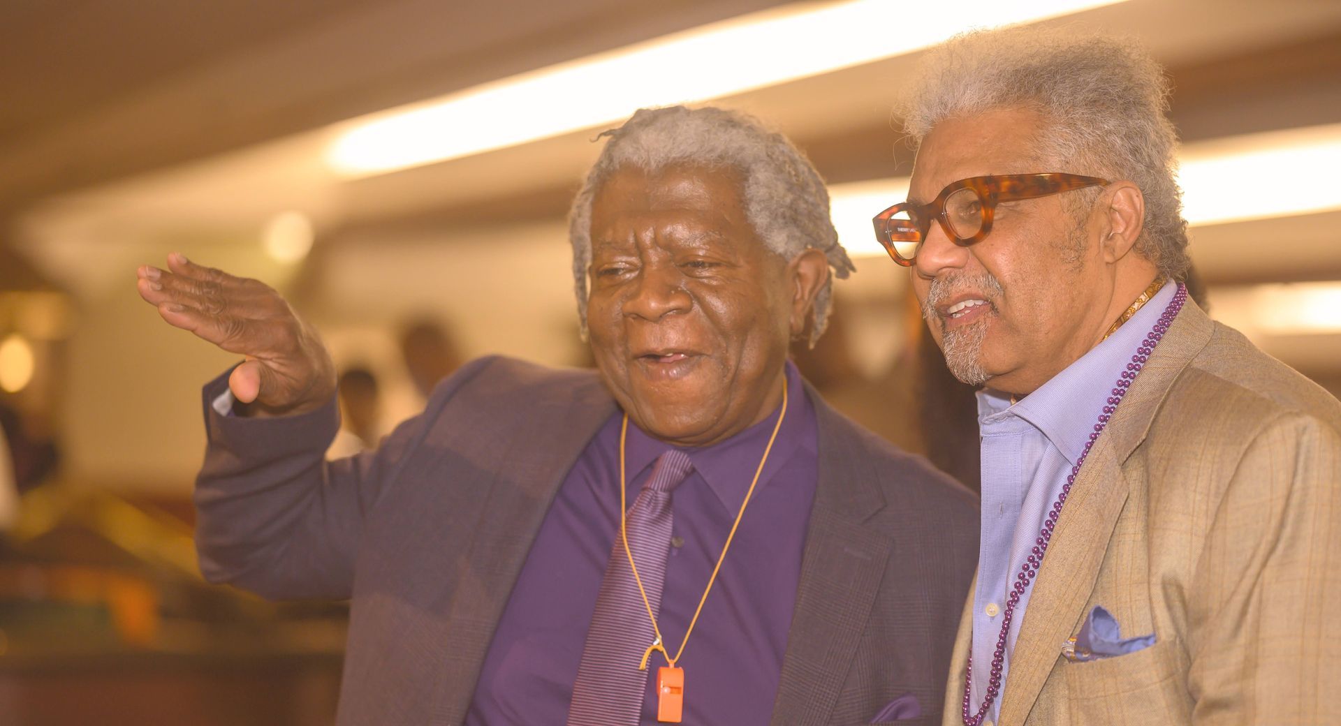 Two men in suits and ties are standing next to each other.