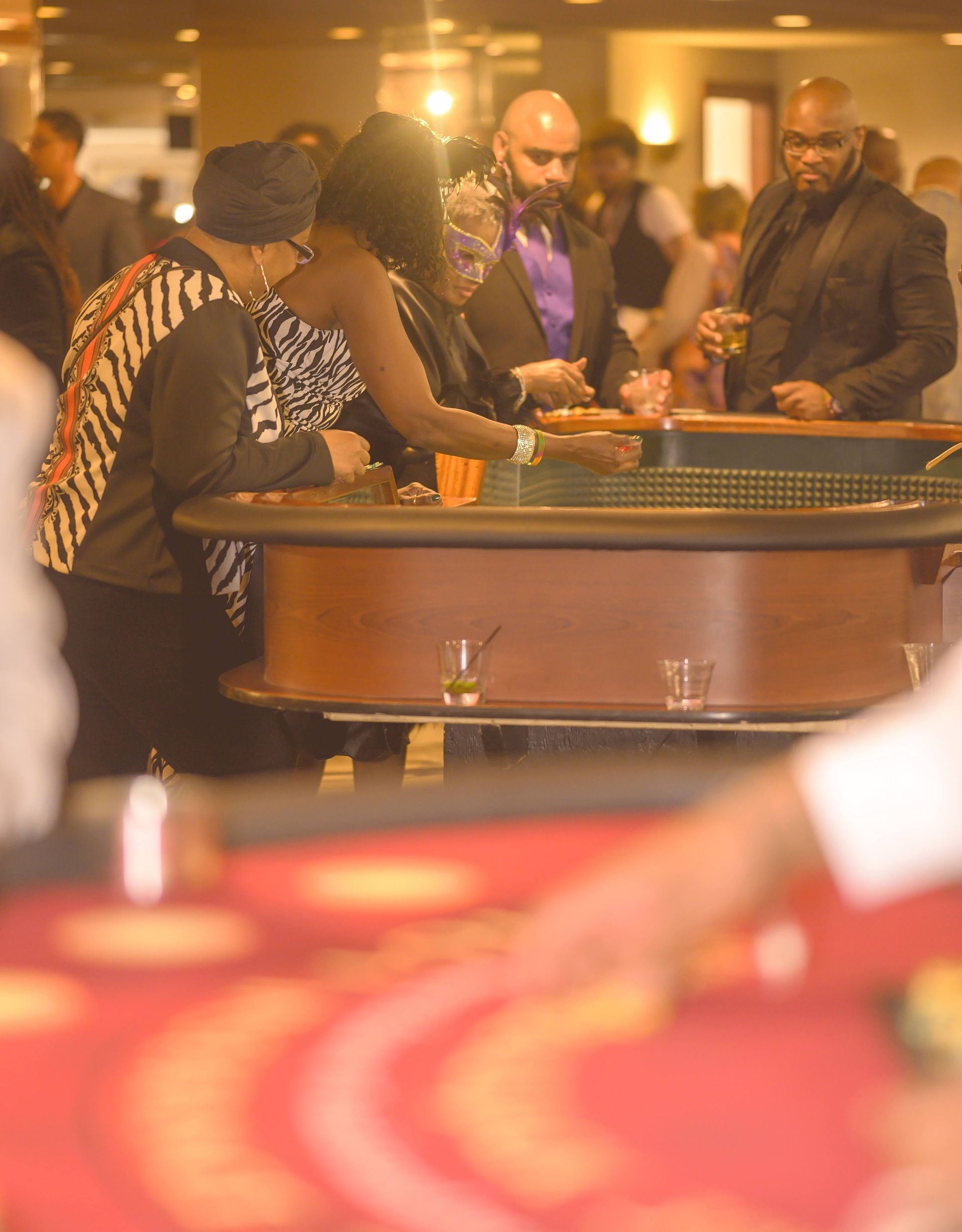 A group of people are playing roulette in a casino.