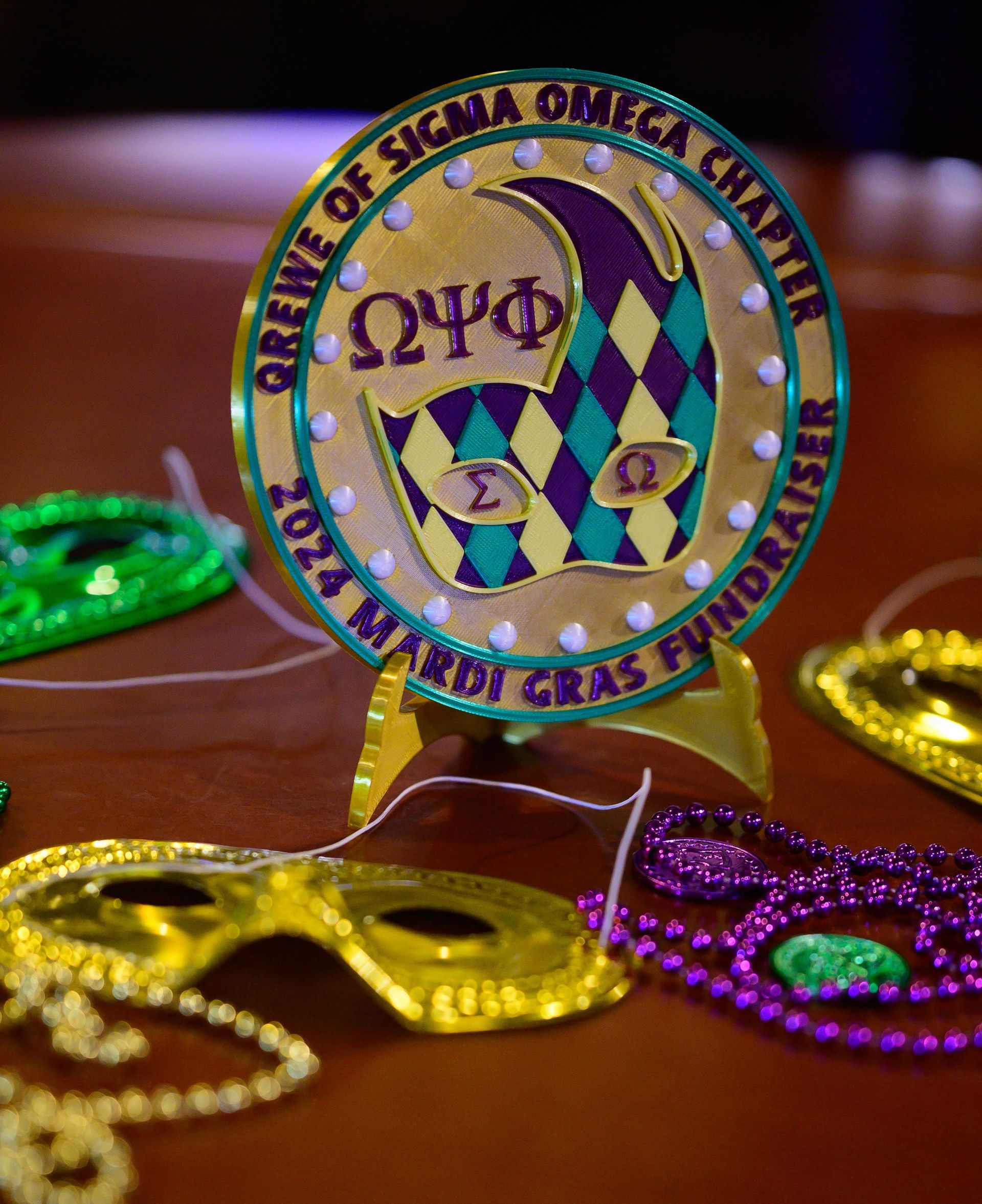 A coin that says orene of sigma omega chapter on it