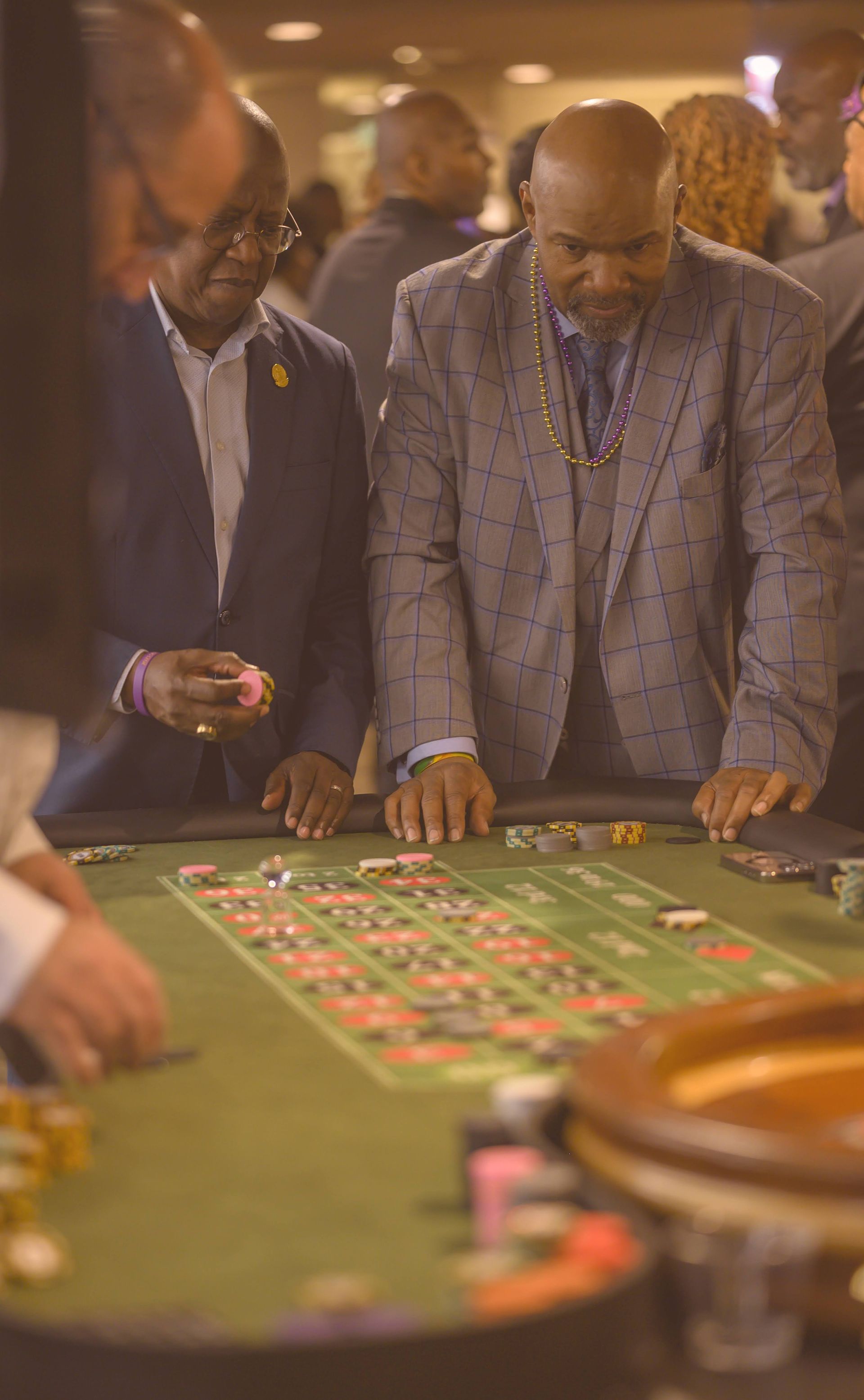A group of men are playing roulette in a casino.