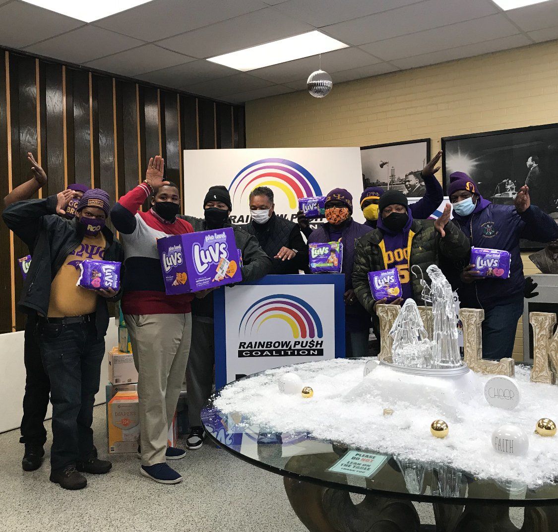 A group of people standing in front of a sign that says boys