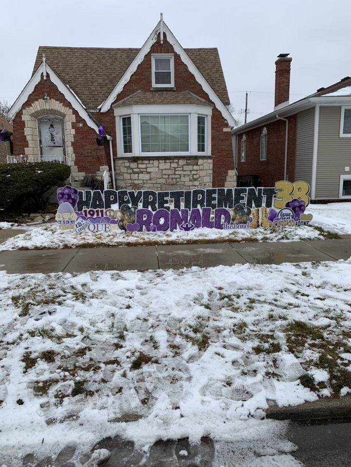 A house with a happy retirement sign in front of it.