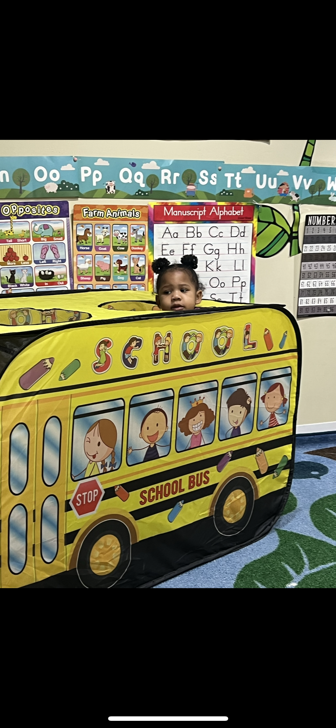 A group of children are sitting at a table eating food.