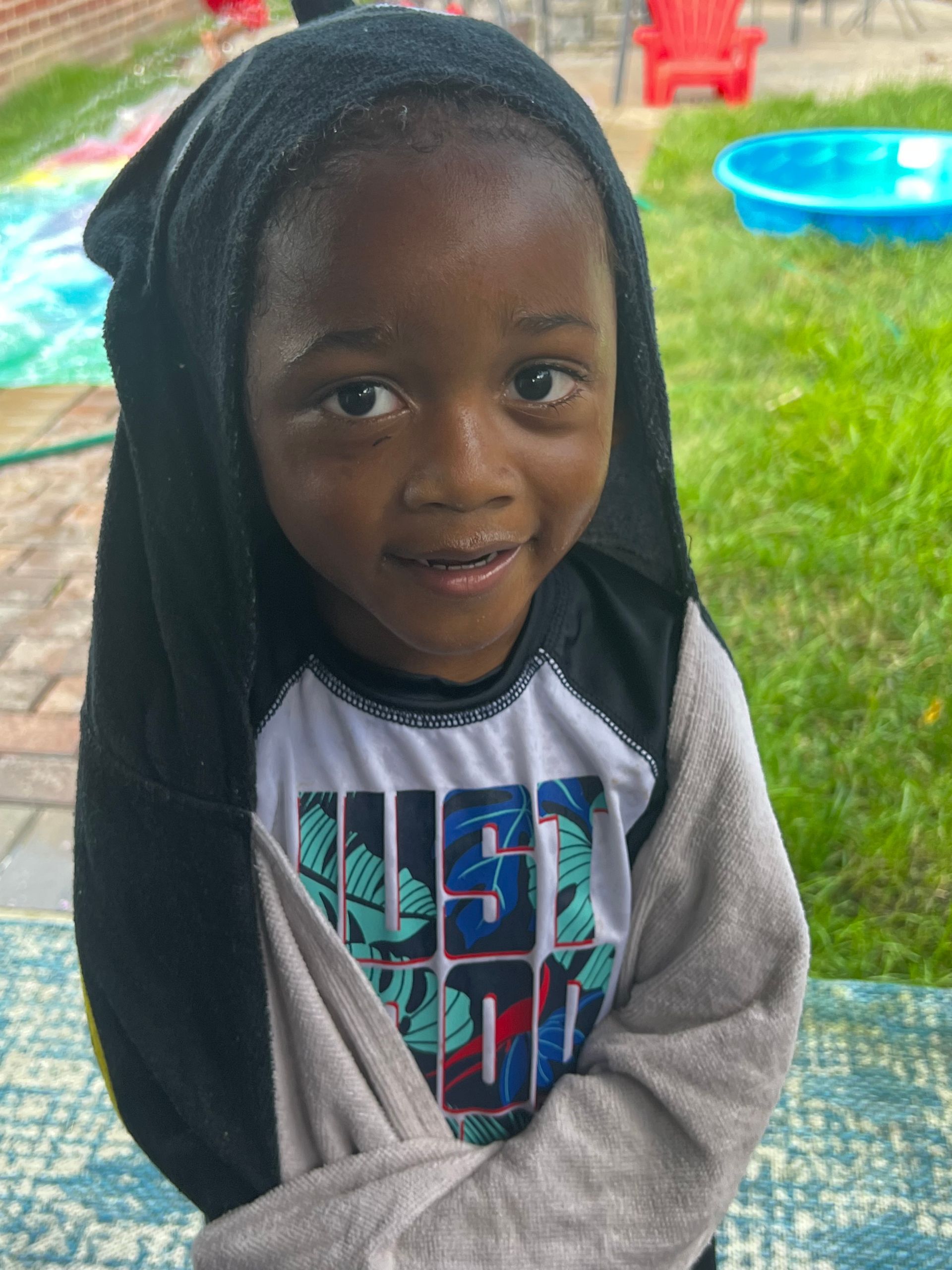 A young boy wearing a shirt that says just do it