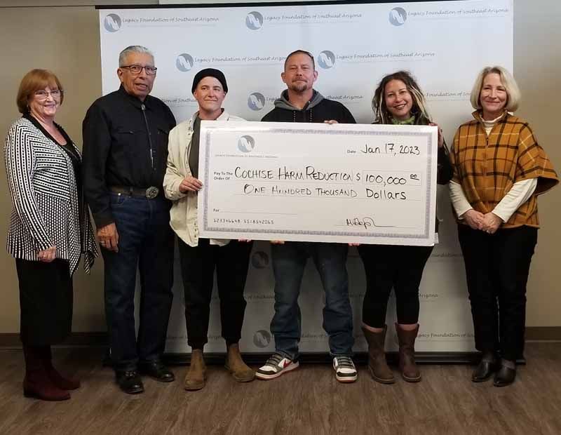 Group of people holding a large check for $100,000, presumably a donation. January 17, 2023.