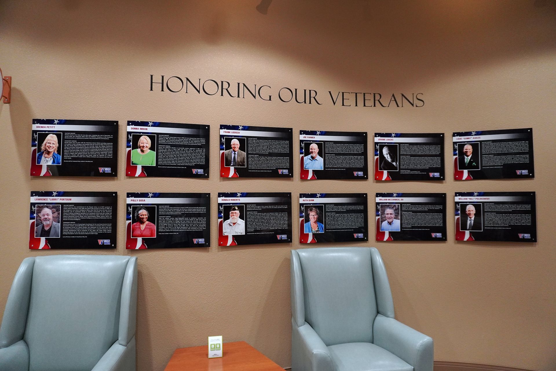 Wall display: Veterans' photos with names and information under 