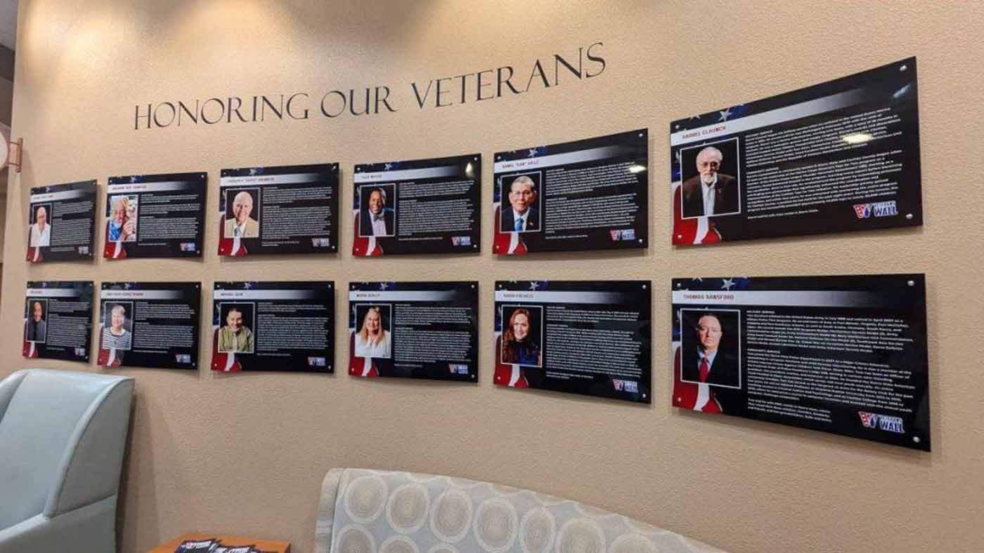 Wall display: Veterans' photos with names and information under 