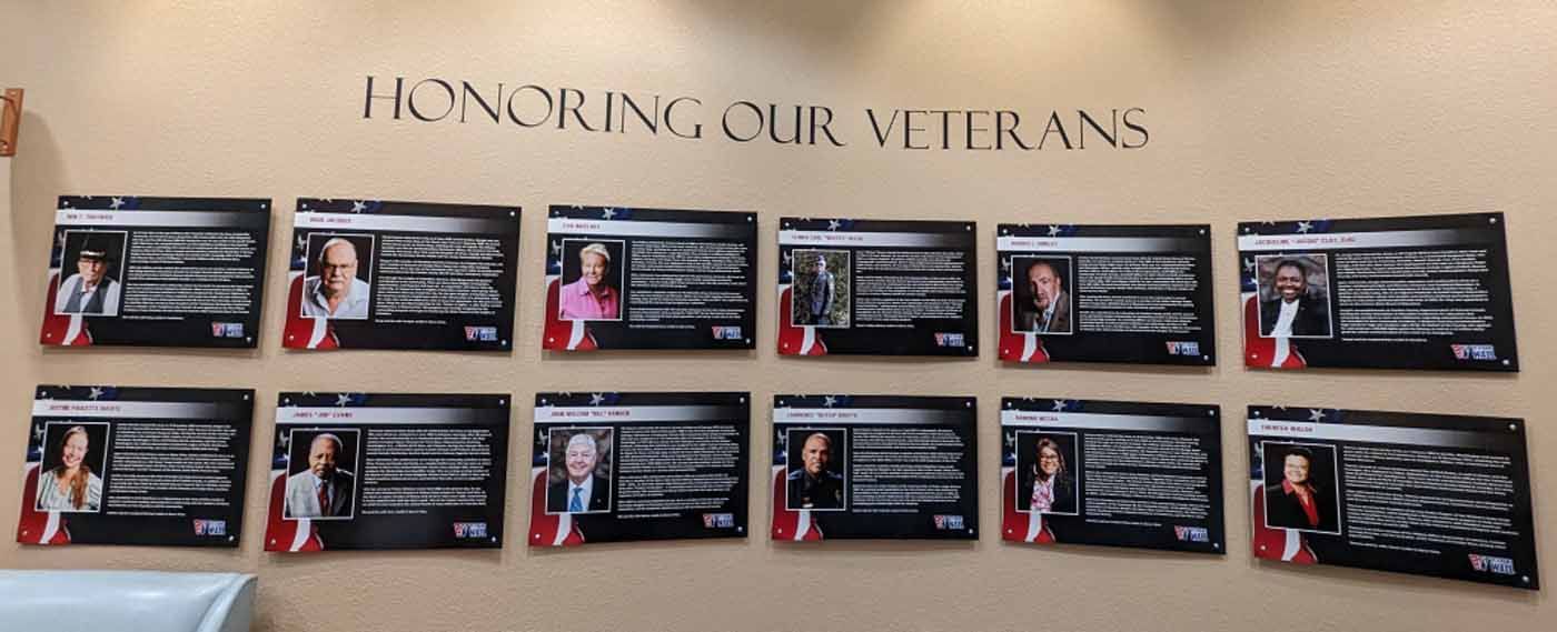 Wall display honoring veterans with photos and text. 