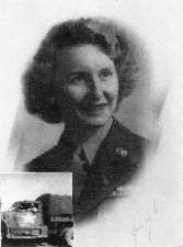 Woman in military uniform, smiling, with a truck in the lower left corner.