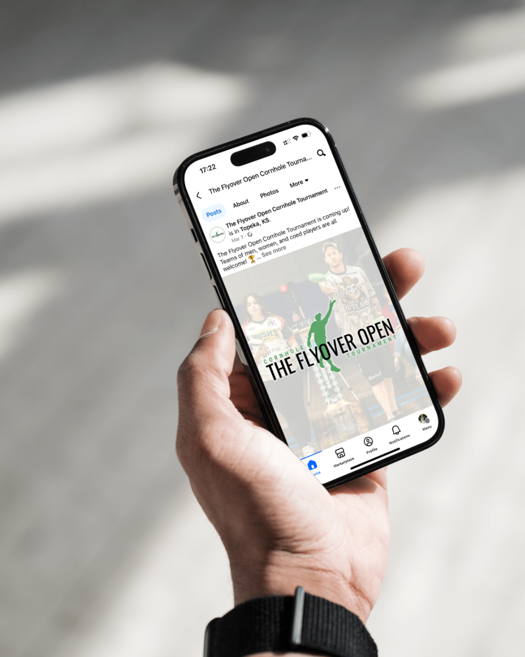 A person is holding a cell phone in their hand.