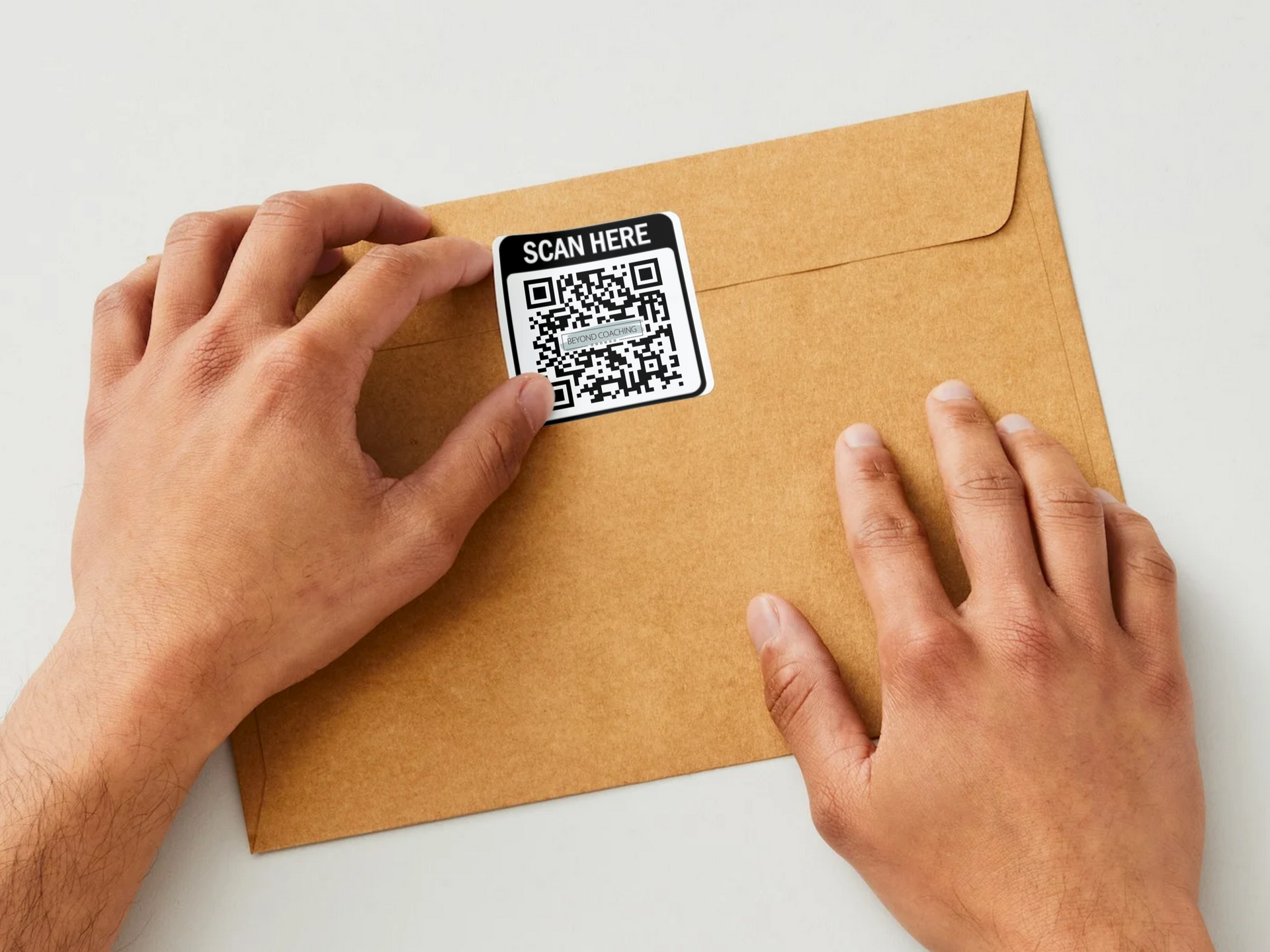 A person is putting a qr code on an envelope.