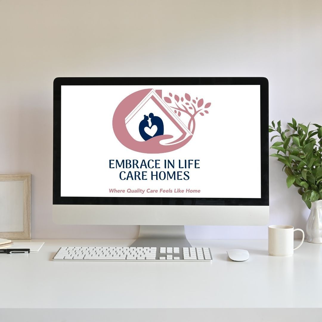 A computer monitor displays the logo for embrace in life care homes