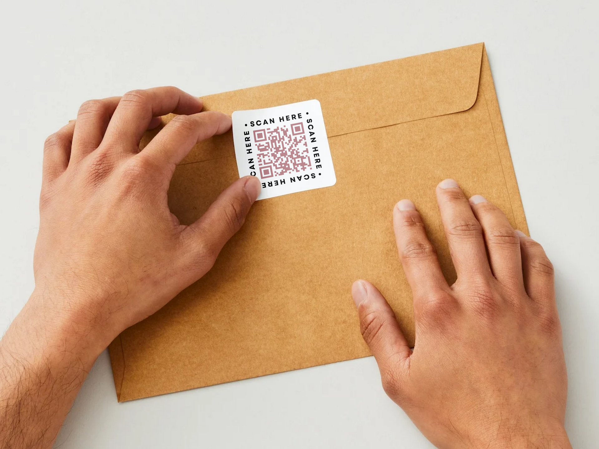 A person is putting a qr code on an envelope.