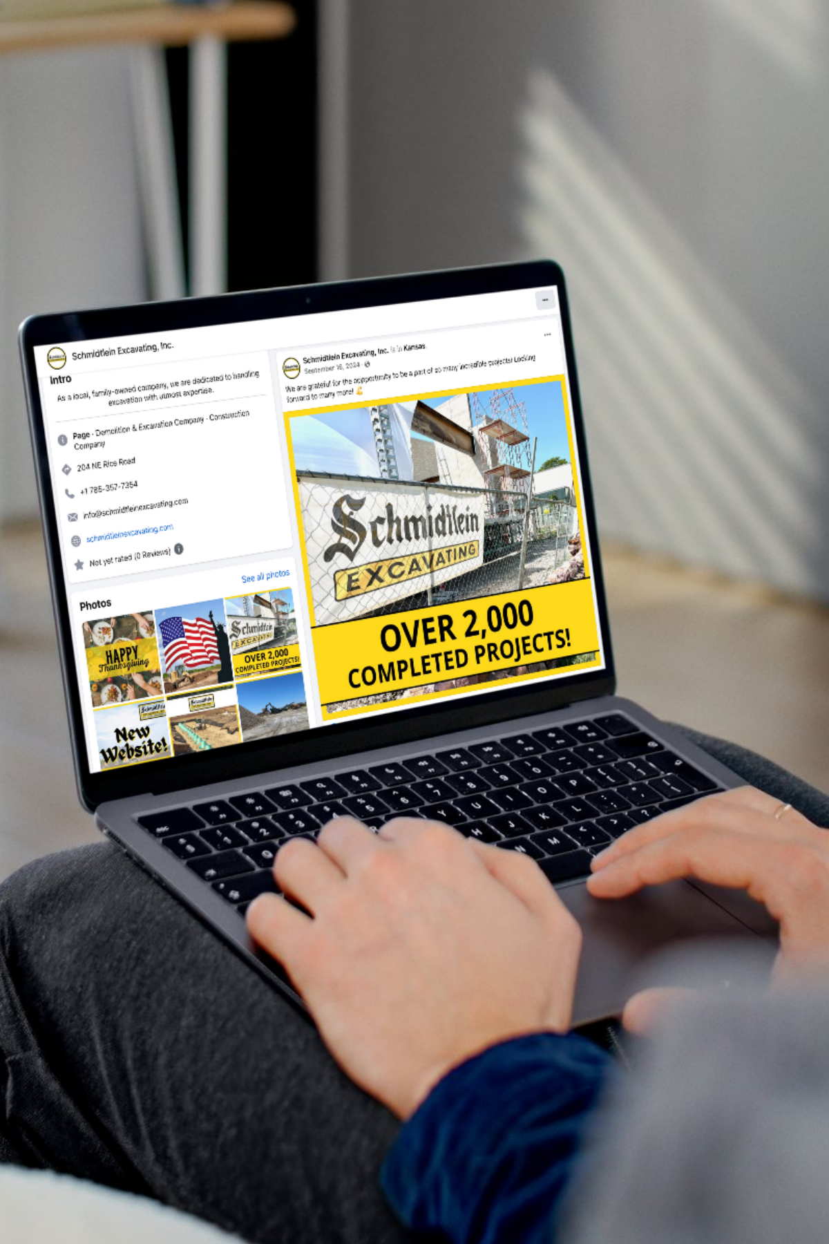 A person is sitting on a couch using a laptop computer.