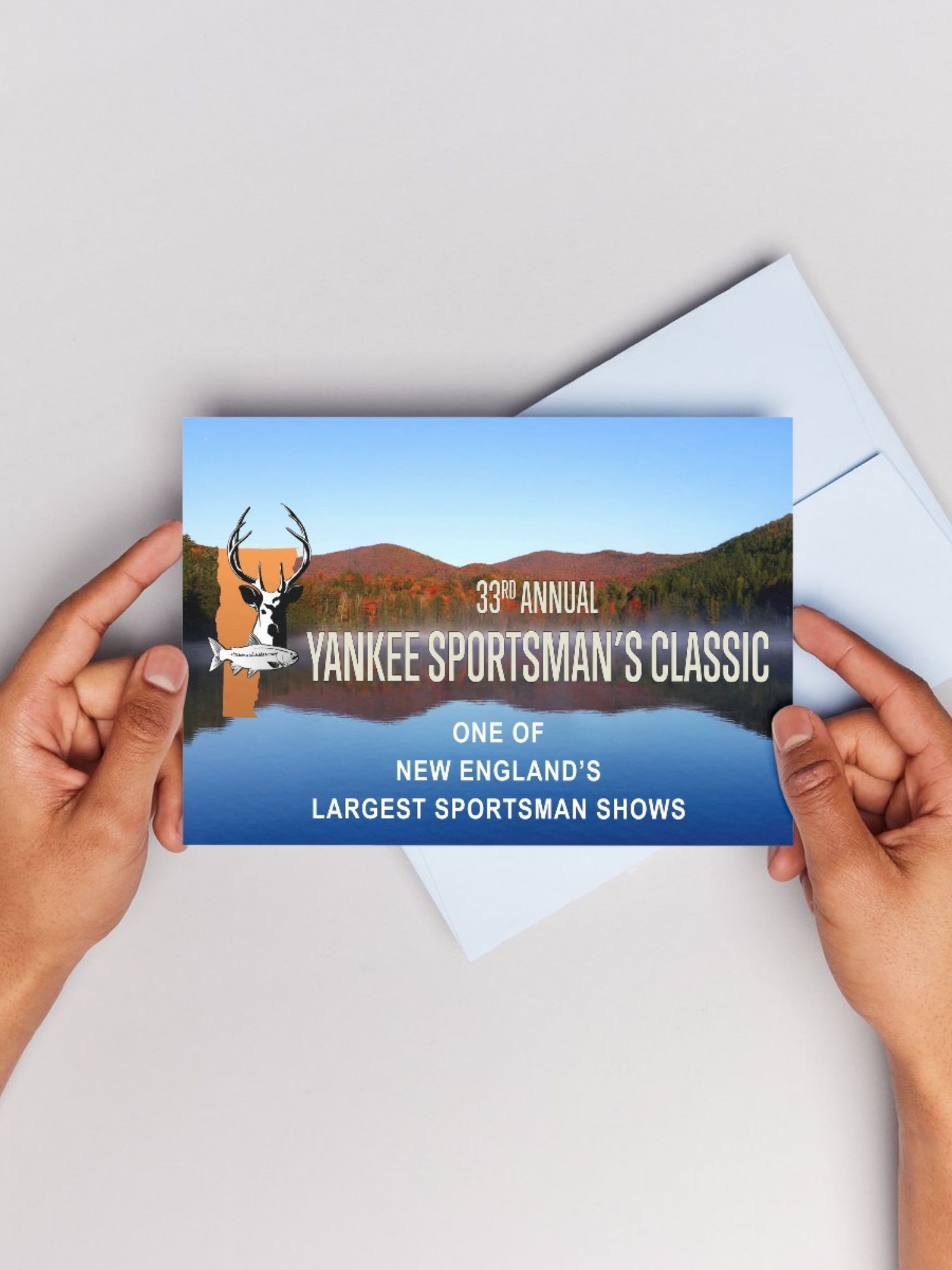 A person is holding a postcard that says yankee sportsman 's classic