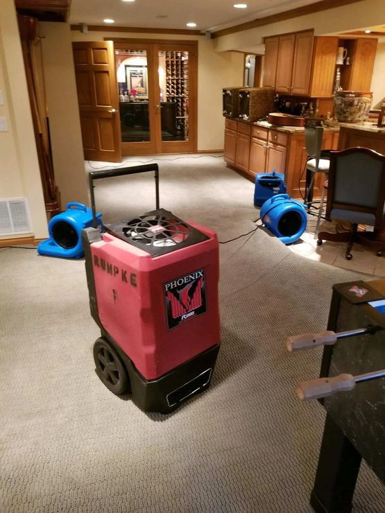 Water damage drying equipment in a basement drying a home