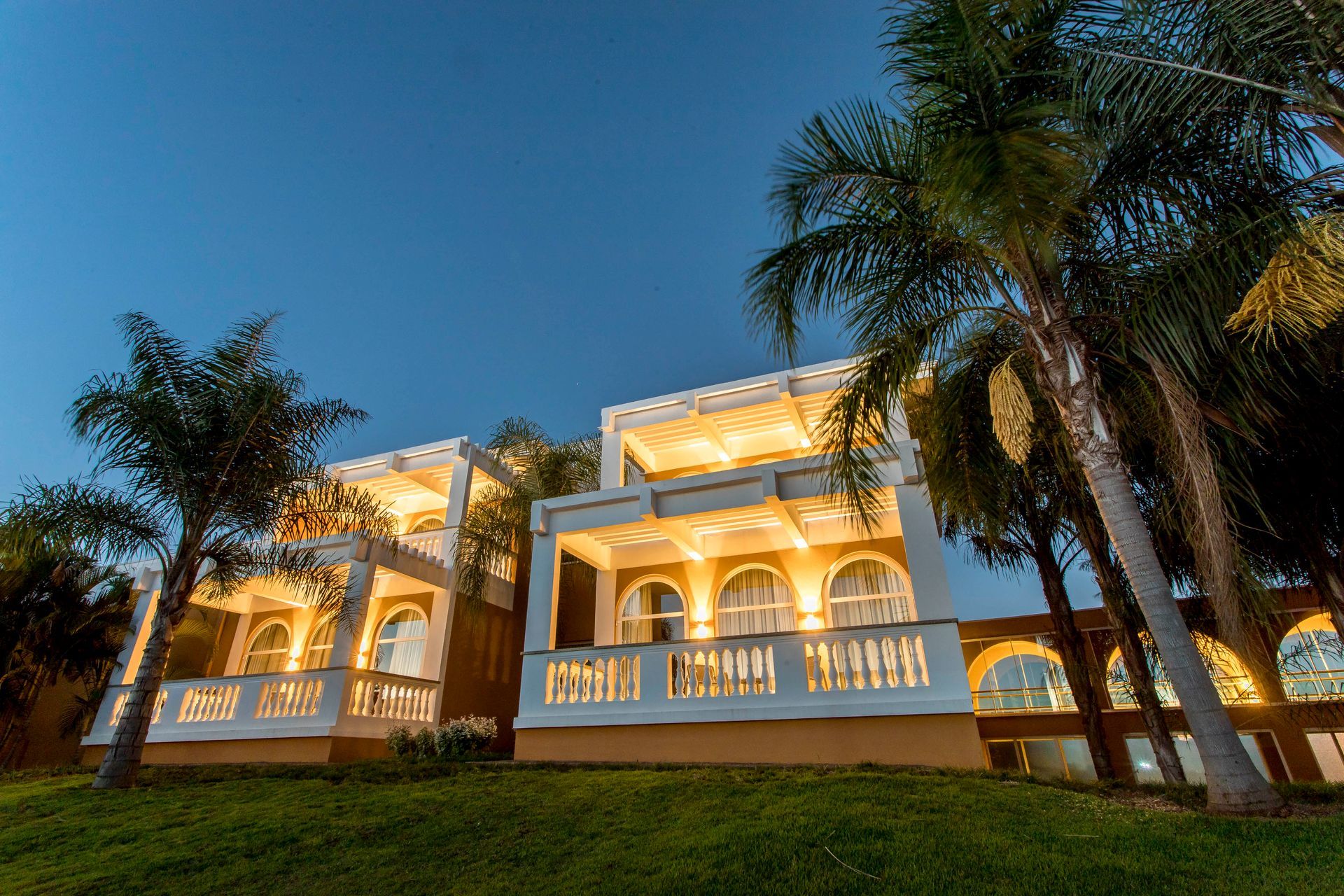 Uma grande piscina cercada por cadeiras e guarda-sóis em um resort.